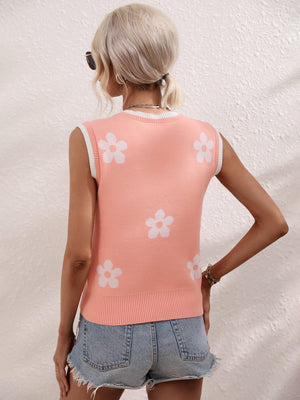 Coral knit tank top with white daisy motif and white trim.