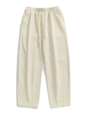 Ivory wide-leg pleated drawstring trousers with a relaxed fit and side pockets.