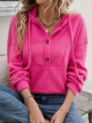 Fuchsia pink button-front drawstring hoodie with textured knit and button details.