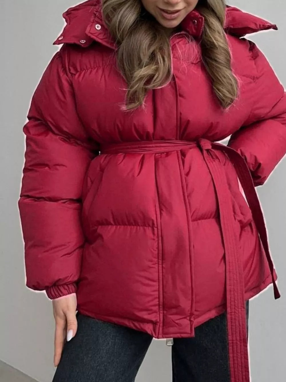 Burgundy puffer trench coat with hood and belted waist.