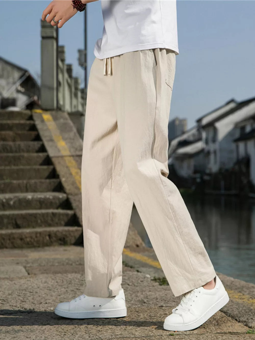 Men's Khaki drawstring sweatpants with a relaxed fit and pockets.