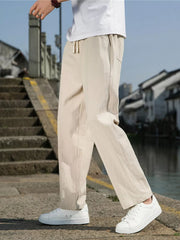 Men's Khaki drawstring sweatpants with a relaxed fit and pockets.