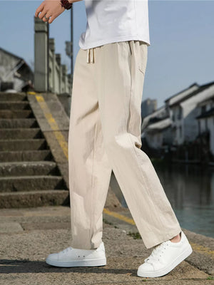 Men's Khaki drawstring sweatpants with a relaxed fit and pockets.