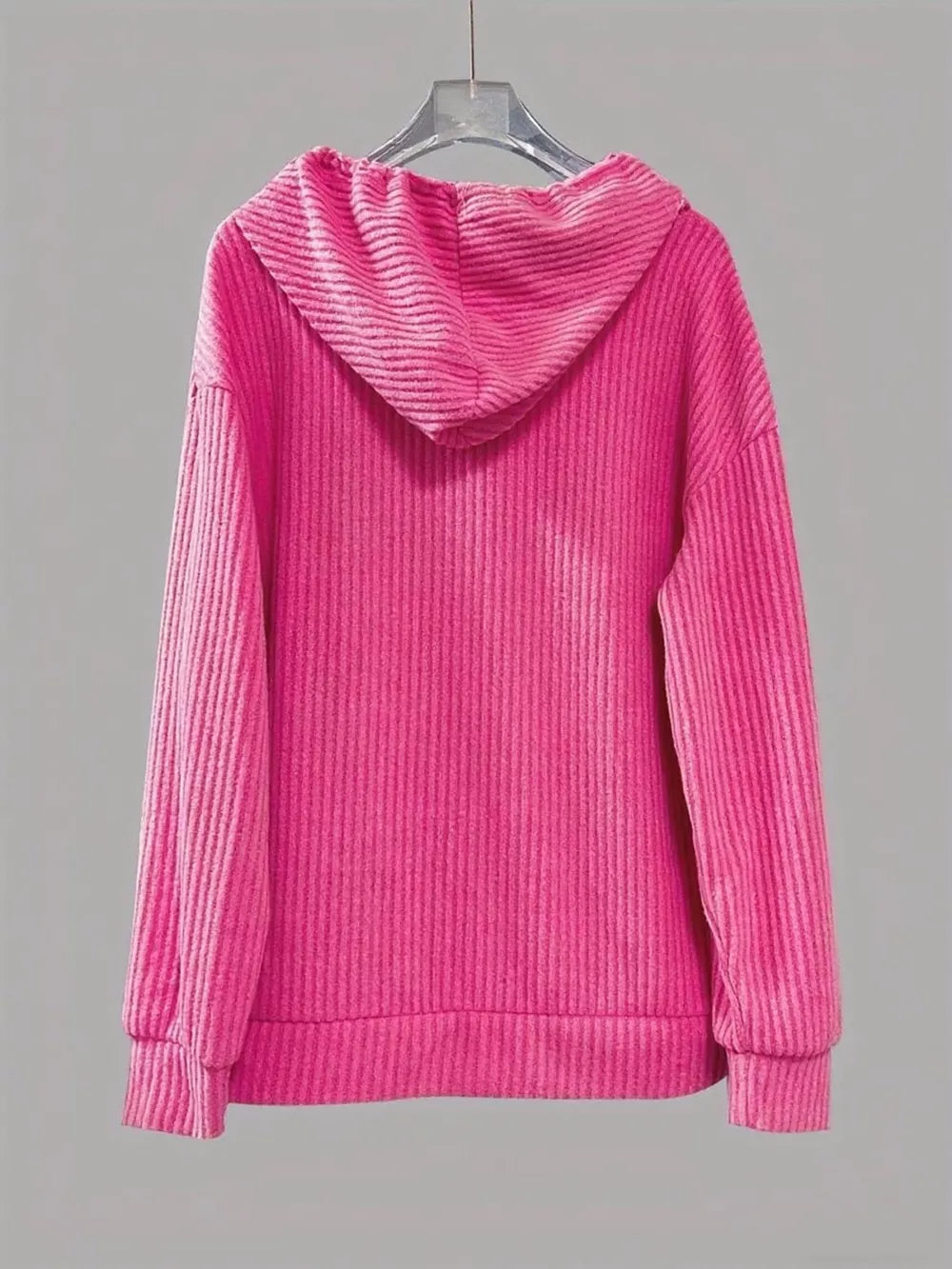 Fuchsia pink ribbed knit hoodie with drawstring and button-front detail.