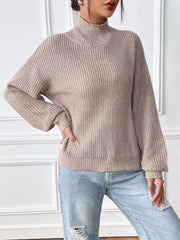 Relaxed fit ribbed knit turtleneck sweater in beige acrylic with balloon sleeves.