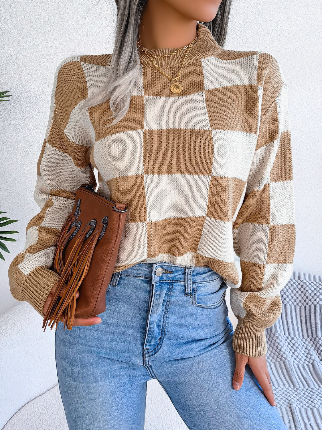 Checkerboard knit mock neck pullover in camel and white acrylic with ribbed cuffs and hem.