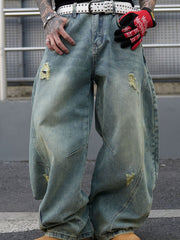 Men's distressed oversized jeans in light blue denim with ripped details.