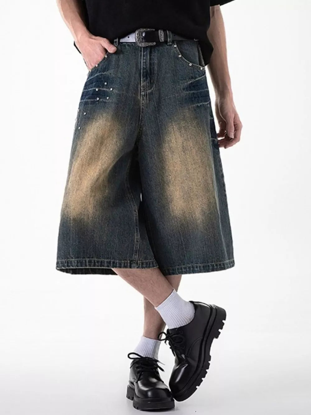 Relaxed fit denim shorts in dark blue with distressed wash and stud details.