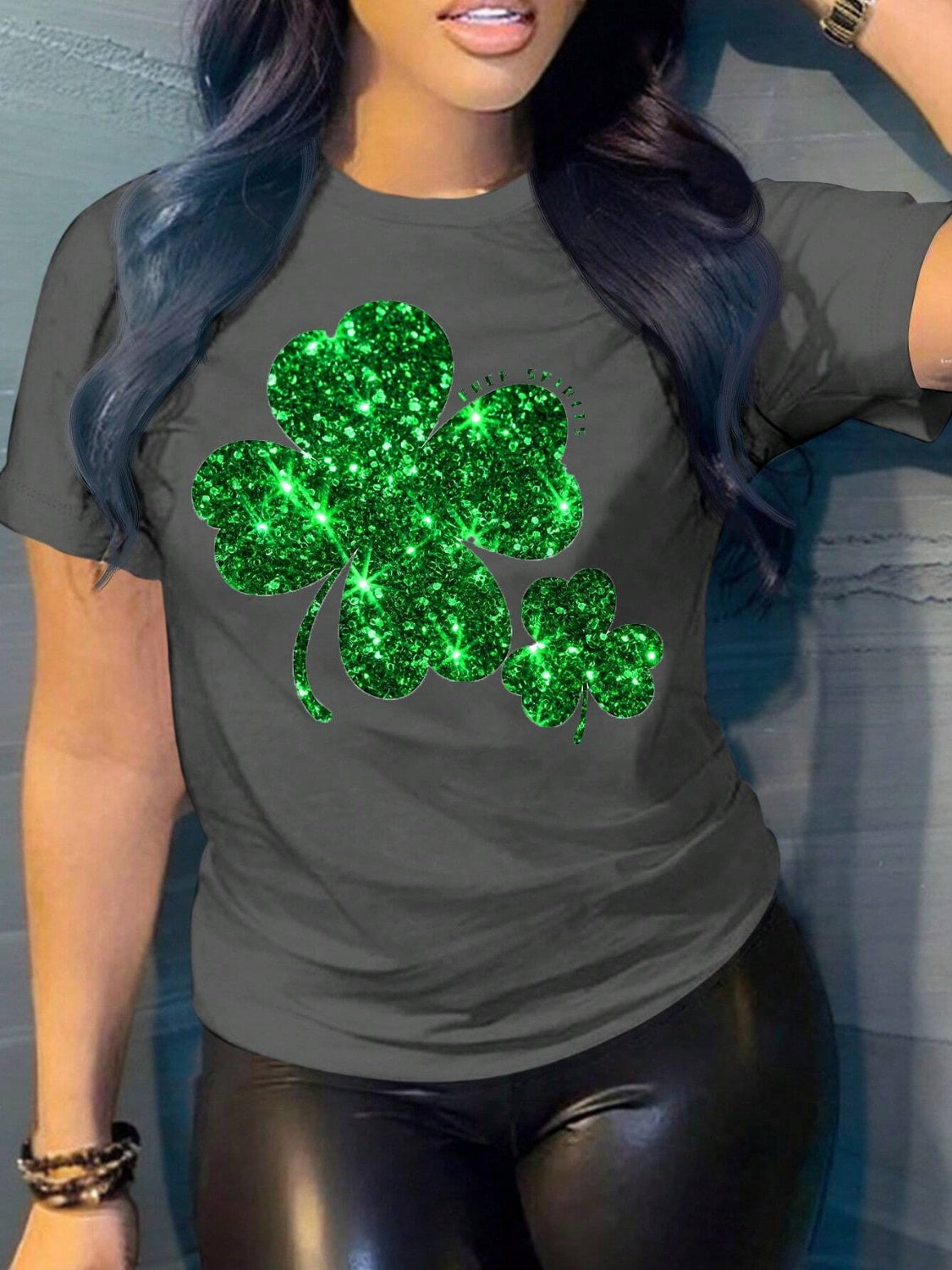 Dark gray t-shirt with a large glittery green shamrock graphic.