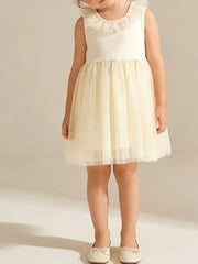 Baby girl's ivory tulle dress with ruffled collar and bow-tie flats.