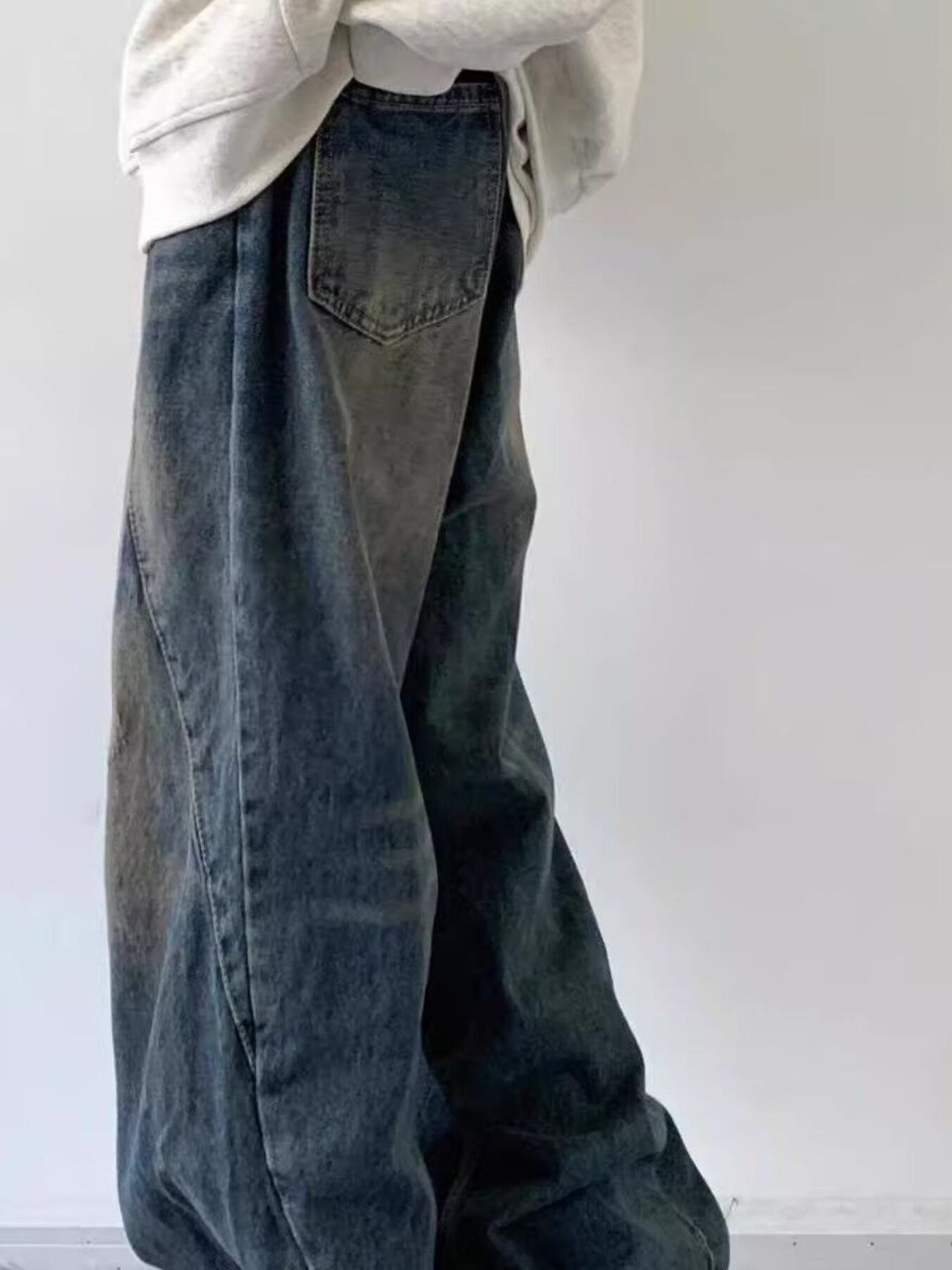 Men's vintage wash wide leg jeans in blue denim with a relaxed fit.