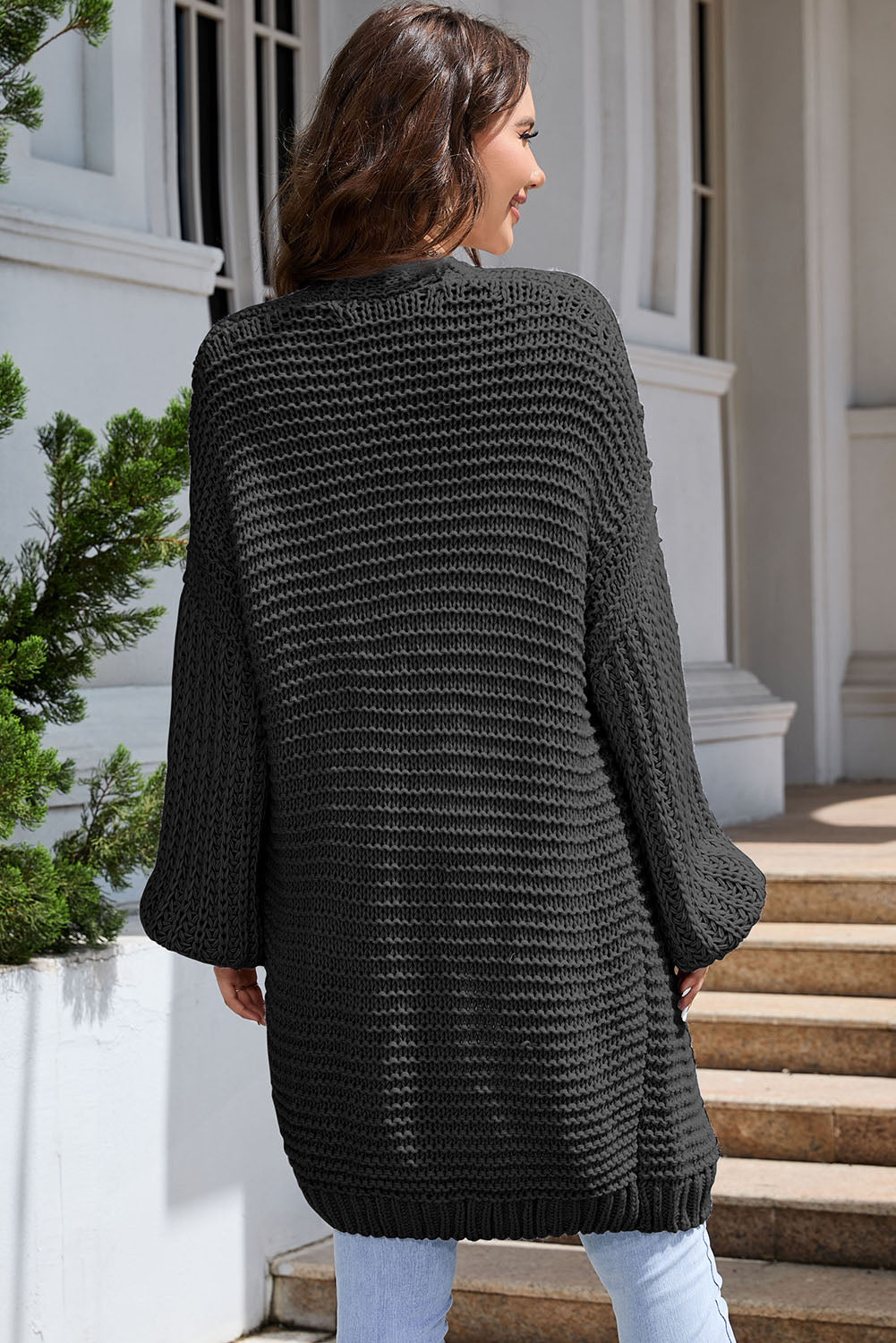 Black textured knit cocoon cardigan with balloon sleeves and a relaxed fit.