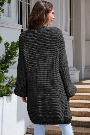 Black textured knit cocoon cardigan with balloon sleeves and a relaxed fit.