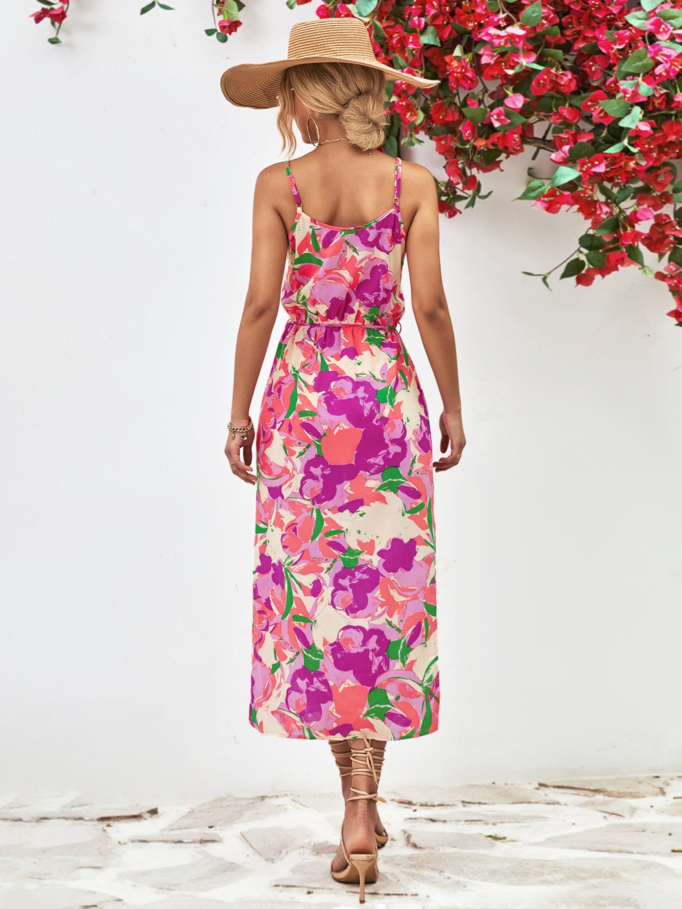 Floral print midi dress in red-violet and orange with spaghetti straps and a cinched waist.