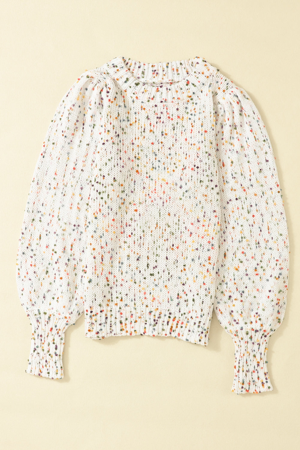 Speckled puff sleeve knit sweater in cream with colorful flecks, crew neck, and ribbed cuffs.