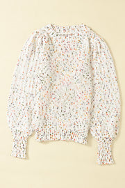 Speckled puff sleeve knit sweater in cream with colorful flecks, crew neck, and ribbed cuffs.