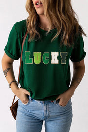 Dark green t-shirt with rolled sleeves and "LUCKY" appliqué text.