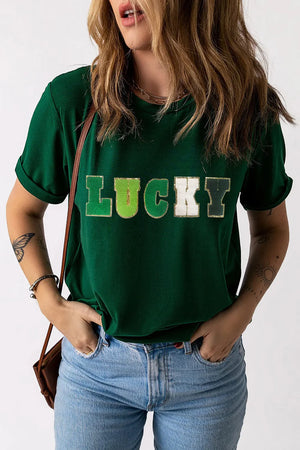 Dark green t-shirt with rolled sleeves and "LUCKY" appliqué text.