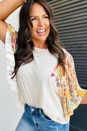 Beige t-shirt with patchwork floral print sleeves and a crew neck.