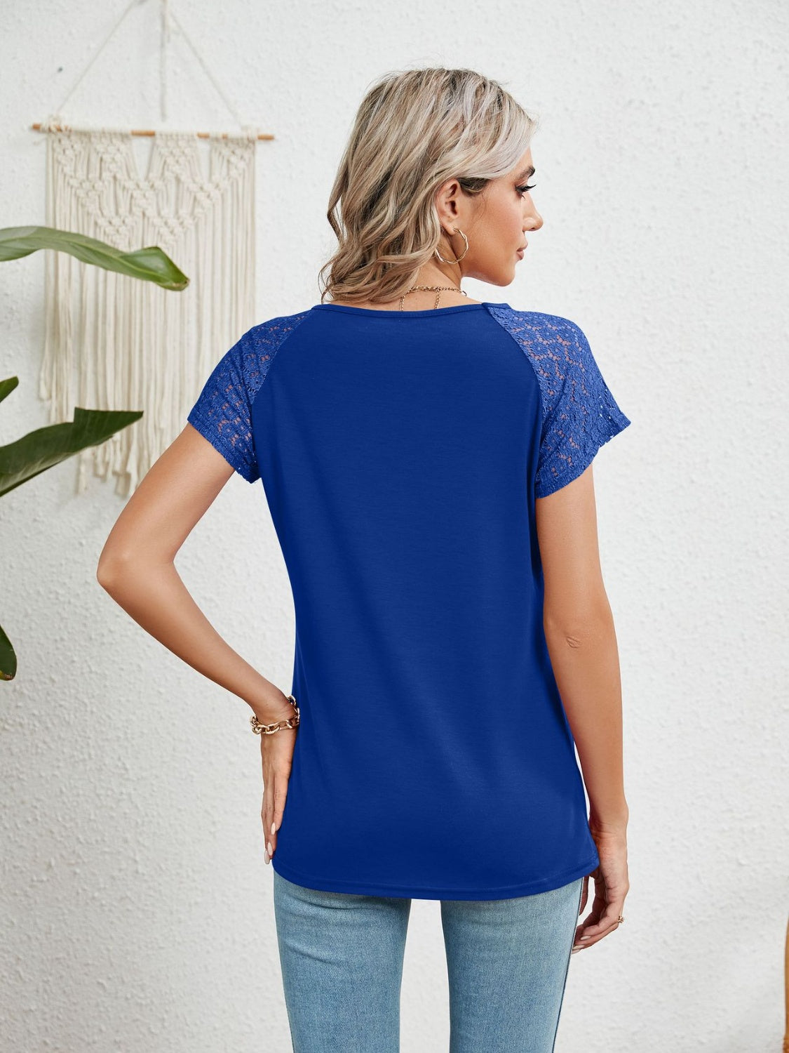 Royal blue polyester blouse with lace short sleeves and a round neckline.