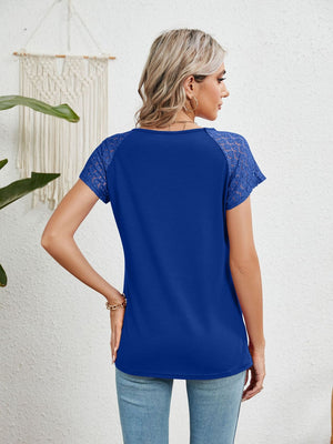 Royal blue polyester blouse with lace short sleeves and a round neckline.