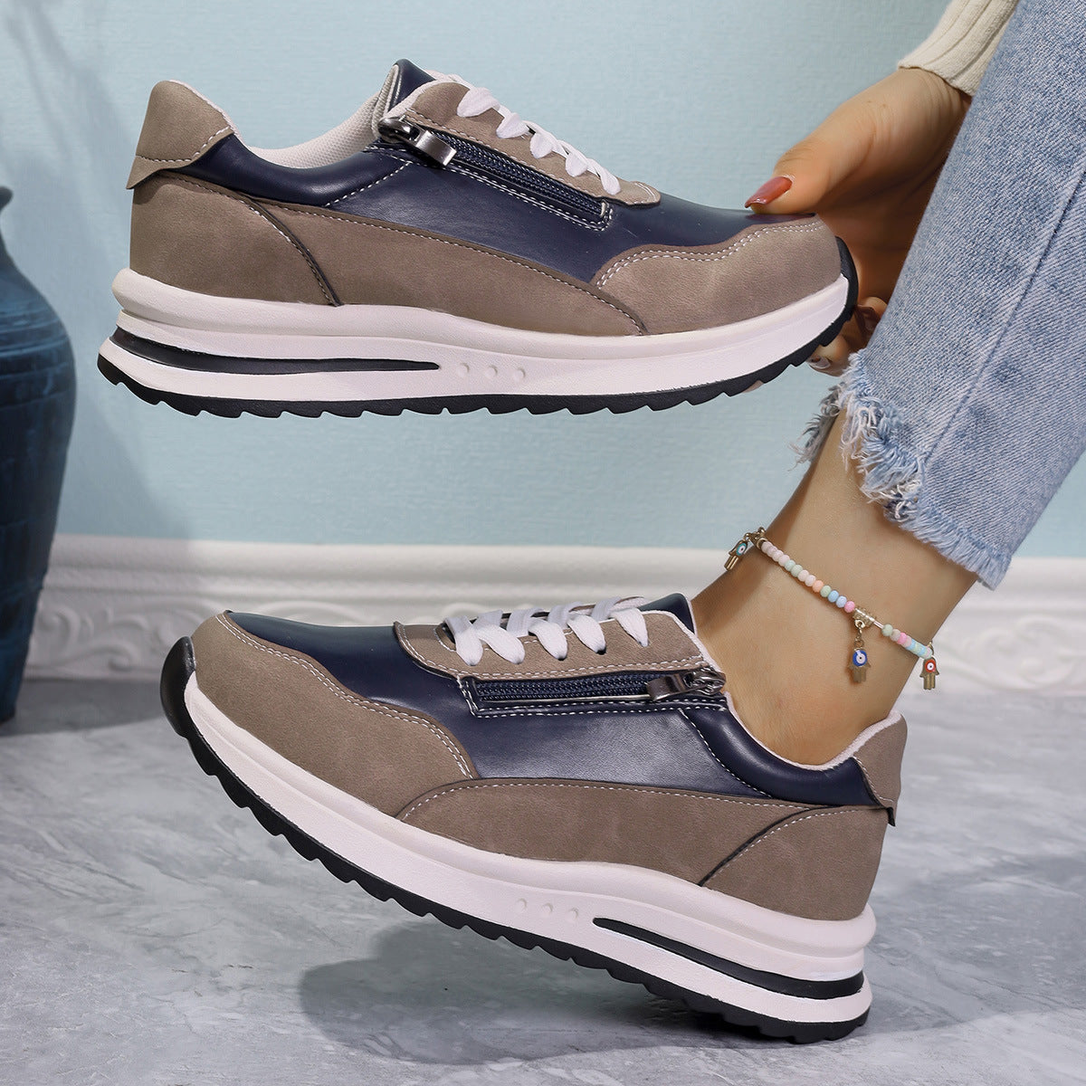 Zipper detail lace up sneakers in navy and tan with a chunky sole.
