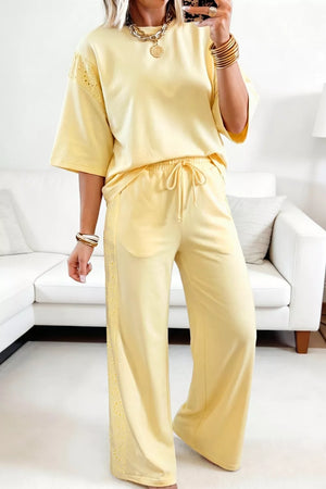 Yellow cotton embroidered half-sleeve top and drawstring pants set with eyelet trim.