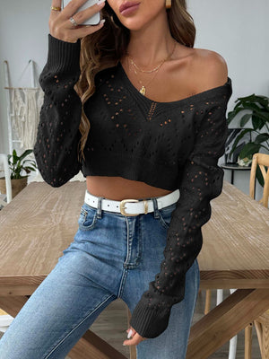 Black cropped pointelle knit polo top with V-neck and long sleeves.