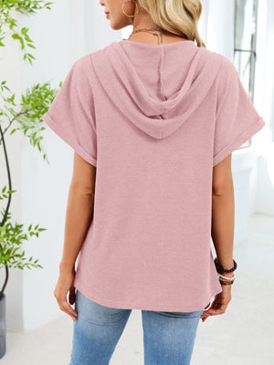 Pink waffle knit short sleeve hooded top with cuffed sleeves.