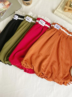 Lace-trimmed gathered waist mini skirts in black, army green, red, and orange.