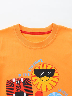 Orange cotton t-shirt for kids with a graphic print of a lion and a smiling sun wearing sunglasses.