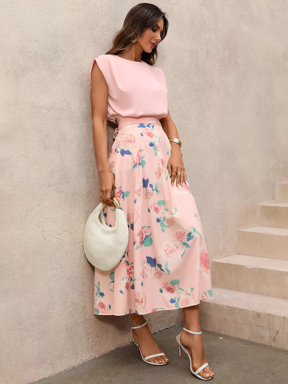Pink structured shoulder top with floral pleated midi skirt set.