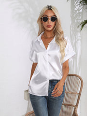 White satin boxy sleeve blouse with button-down front and cuffed sleeves.