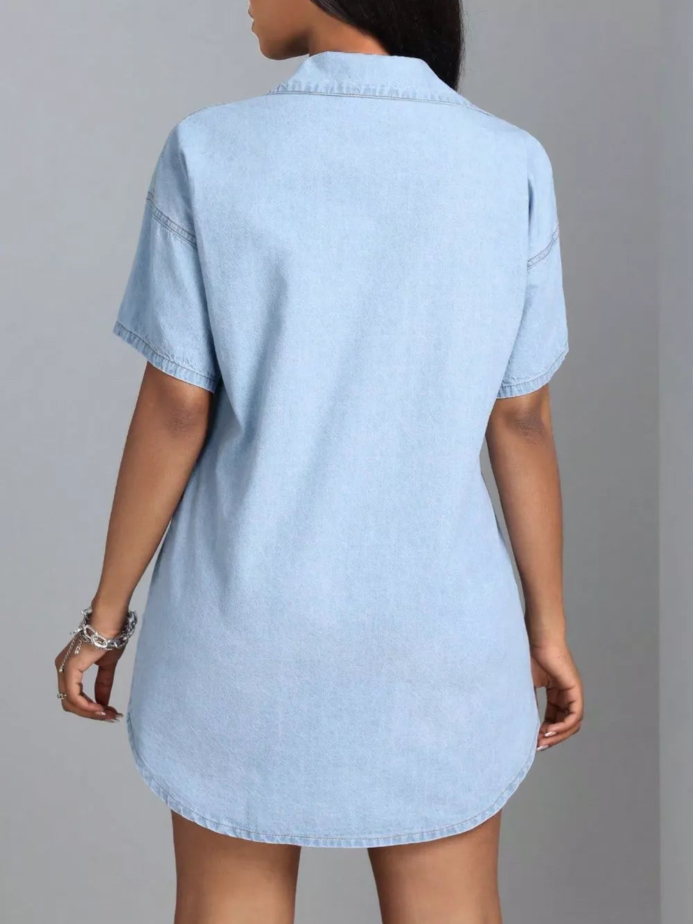 Light blue denim shirt dress with short sleeves and collared neckline.