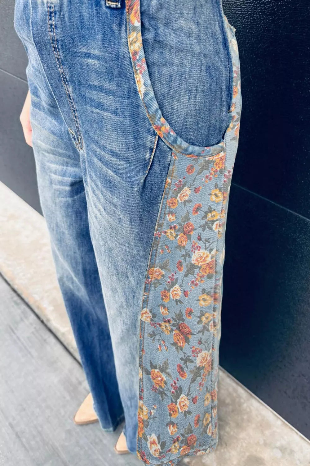 Denim overalls with vintage floral print side panels and straps.