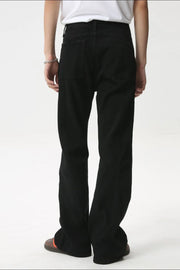 Black denim jeans with flare leg and panel seams, shown from the back.