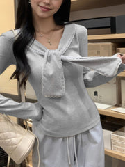 Gray striped ribbed long sleeve top with lace trim and tie detail.