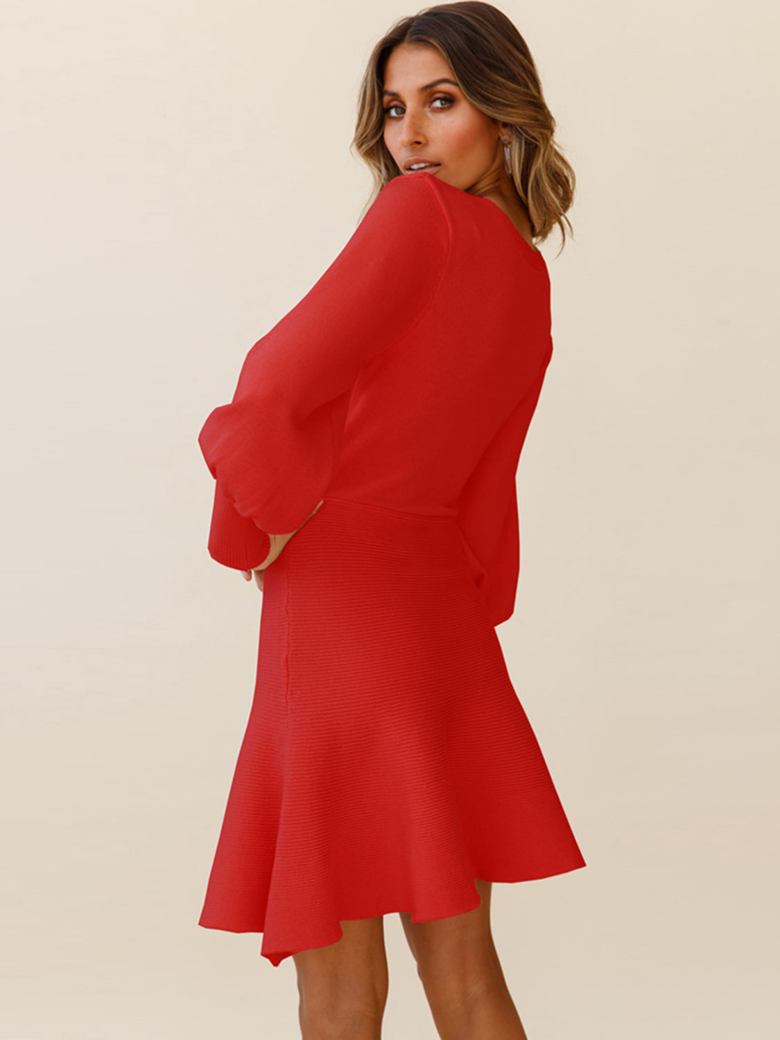 Red knit fit-and-flare dress with balloon sleeves and ribbed skirt detail.