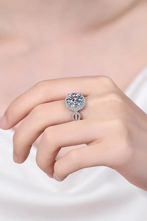 Sterling silver halo moissanite ring with a sculpted band and pavé accents.