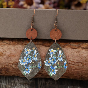 Botanical wood teardrop earrings in light blue with floral print and copper hooks.