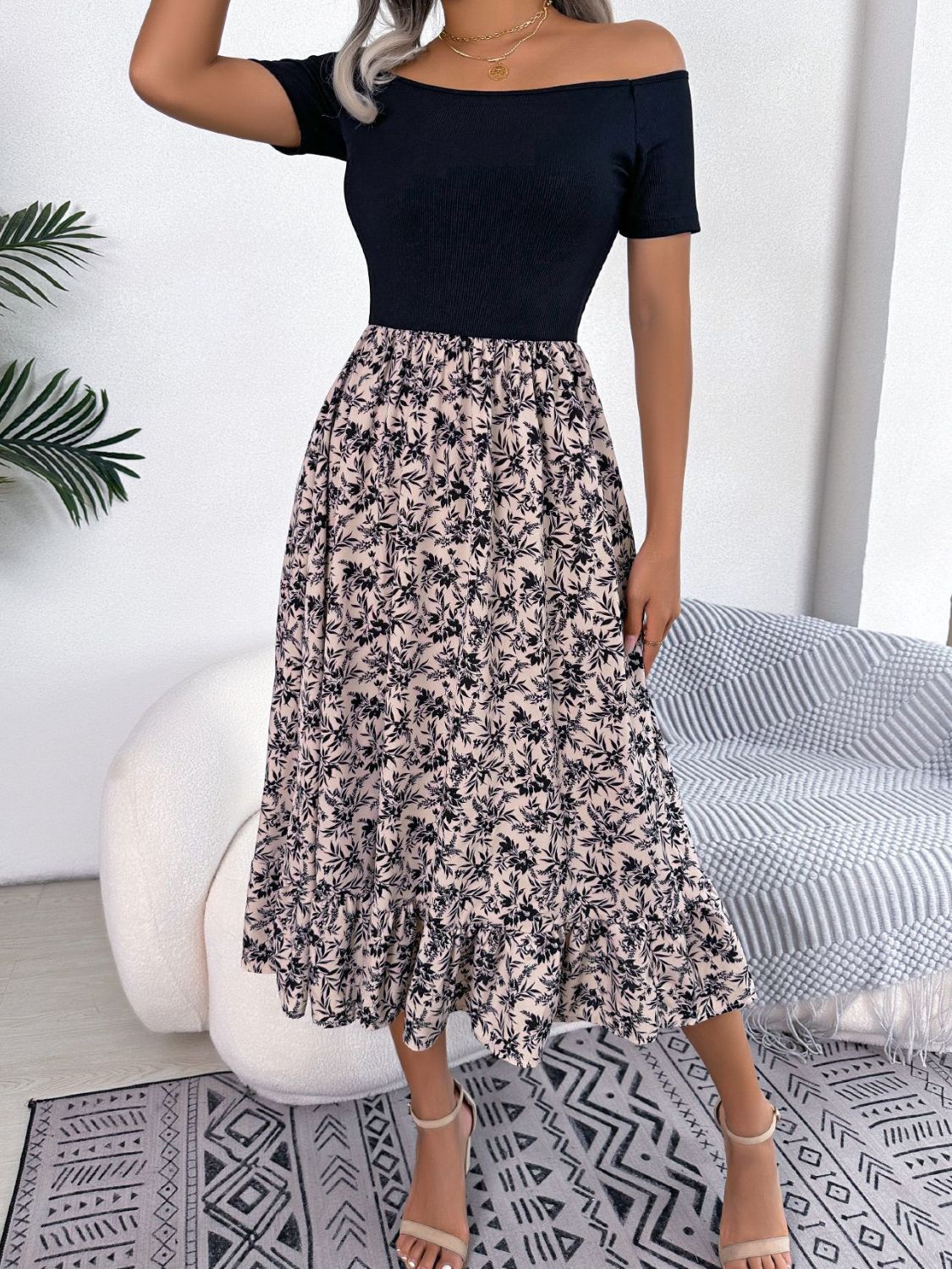 Floral print off-shoulder midi dress with black bodice and ruffled hem.
