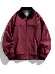 Oversized zip-up jacket in Sauce Fruit Red with a black collar and plaid lining.