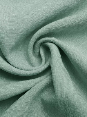 Maternity maxi dress fabric detail in sage green linen-look texture with ruffles.
