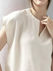 White cap sleeve shirt with notched neckline and relaxed fit.