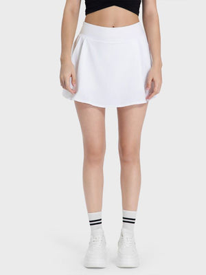 White pleated performance mini skirt with a comfortable fit