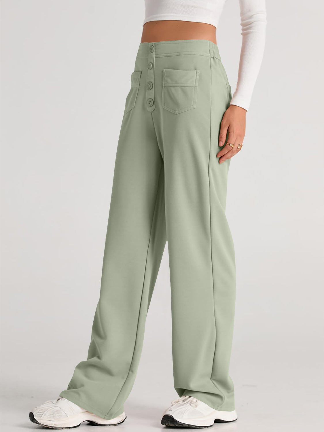 Button-front palazzo trousers in Gum Leaf green with wide legs and pocket details.