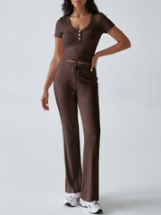 Brown button-front crop top and flared lounge pants with drawstring waist.