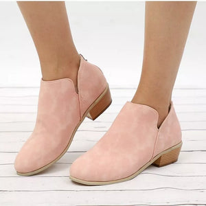 Pink V-cut pointed toe block heel boots with a wooden heel detail.