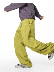 Relaxed fit cargo pants in Mustard Yellow with drawstring and zippered pockets.