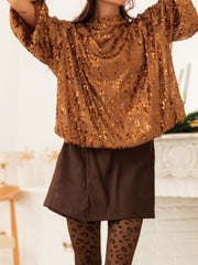 Dazzling sequin tie-back shirt in ochre with mock neck and dolman sleeves.